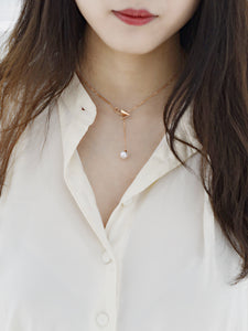 “Origaminx Airplane” 18K gold and Akoya pearl, origami-shaped necklace